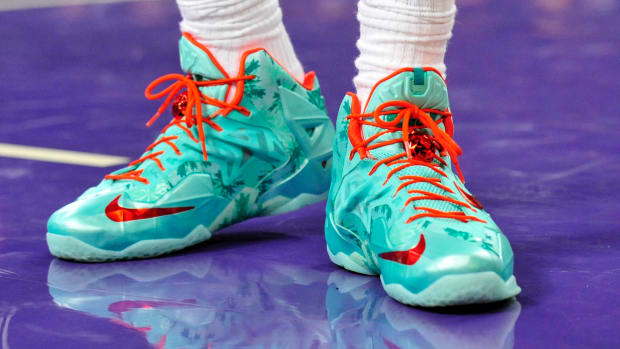 View of green and red Nike LeBron shoes.